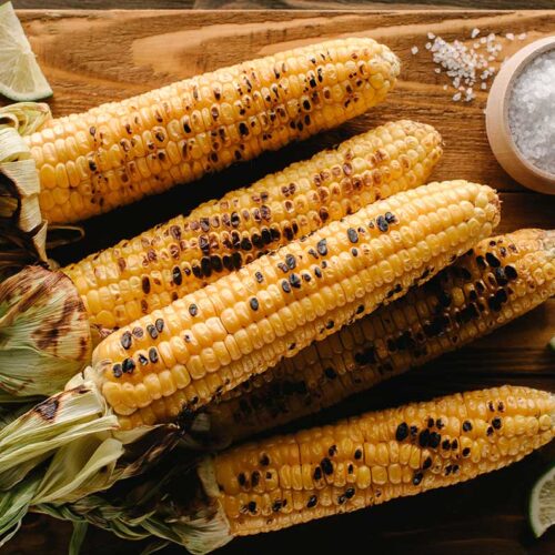 Delicious Mexican Grilled Corn on the Cob on a Cutting Board