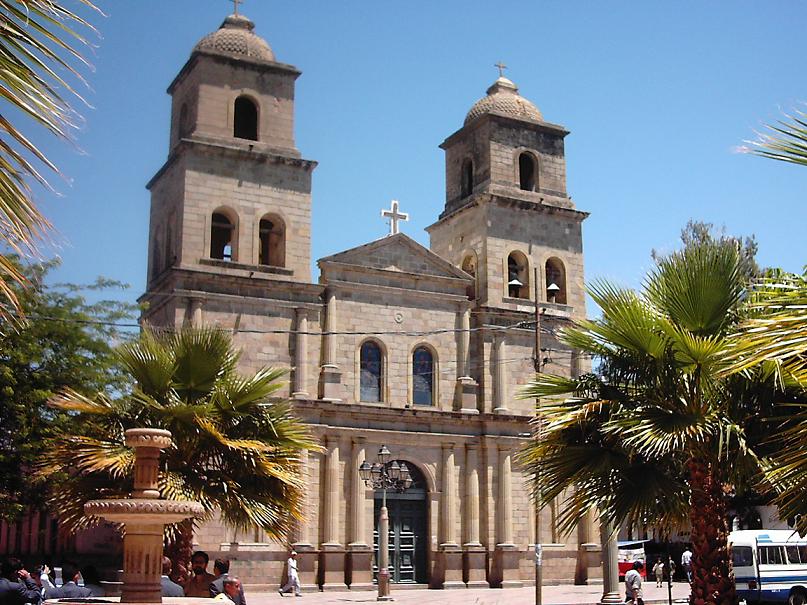 A striking image of the serene and elegant Iglesia de San Bernardo in Tarija, Bolivia, with its Spanish Colonial architecture and sunny blue skies.