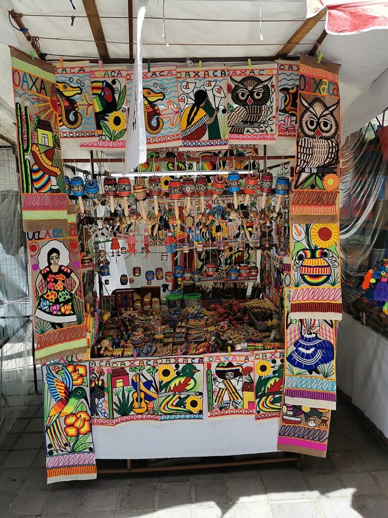 A vibrant display of handmade crafts at a street vendor's stall in the Oaxaca zócalo.